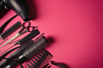 Hairdresser set with various accessories on pink background