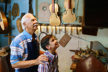 Old Man Grandpa Showing Guitar To Boy Grandson