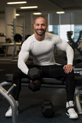 Fototapeta na wymiar Young Healthy Man Doing Exercise For Biceps