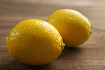 Fresh lemons on wooden background
