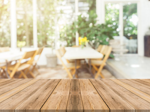 Wooden board empty table in front of blurred background. Perspective brown wood over blur in coffee shop - can be used for display or montage your products.Mock up for display of product.