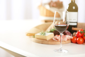 Glass of wine with food on table closeup