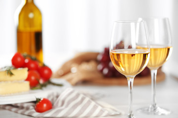 Glasses of red wine with food on table closeup