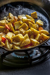 Frying up potatoes in a skillet.