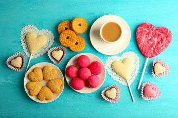 Valentine concept. Composition of cookies and candies on blue background