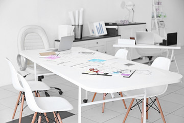 Table of architect with drafts and clipboard in the office