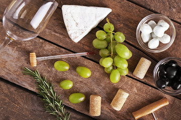 Wine, snacks and different various of cheese, flat lay