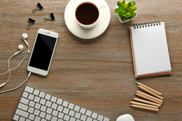 Workplace with mobile phone on wooden table