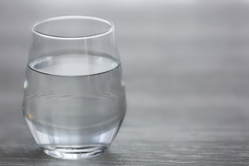Glass of water on wooden background