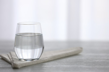 Glass of fresh water on wooden table