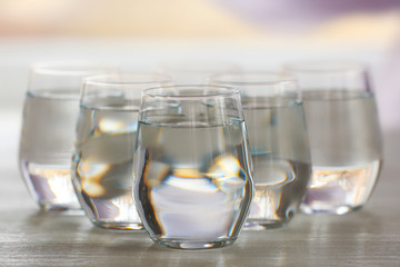 Glasses of water on wooden background