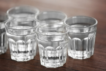 Glasses of water on wooden background