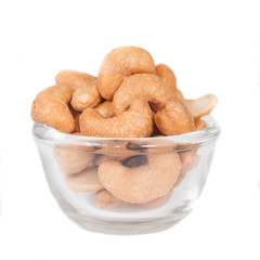 Glass bowl full with cashew nuts. Isolated on a