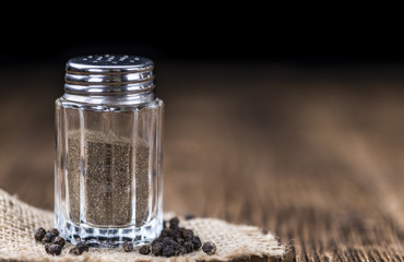 Old wooden table with a Pepper Shaker