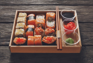 Set of sushi maki and rolls at black rustic wood. © Prostock-studio