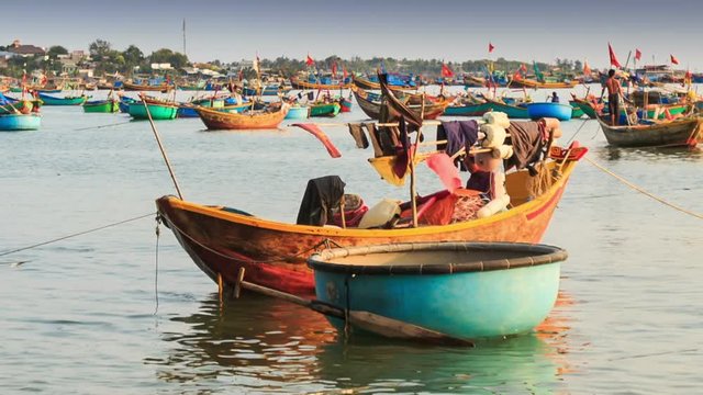 Round and Long Fishing Boats Float in Sea Bay in Vietnam