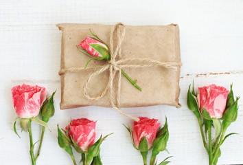 Handmade gift wrap idea, parchment paper, twine, decorated with delicate garden roses.
