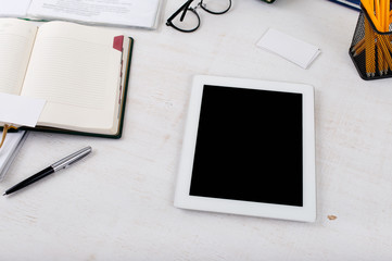 workplace with white tablet computer with blank screen
