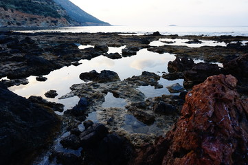 The texture of the stones and wet earth. Stones in the drying puddle