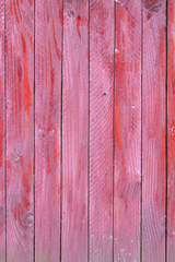 vertical planks of red painted worn planks on fence or door