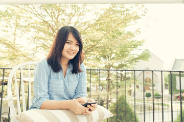 Youth and technology. Young attractive long hair woman using smartphone while sitting at cafe.