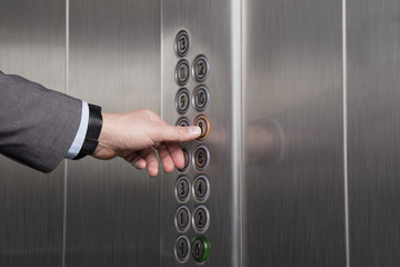Pressing the button in the elevator