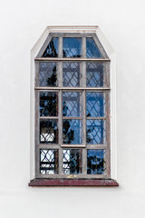 Ancient window on a white fall