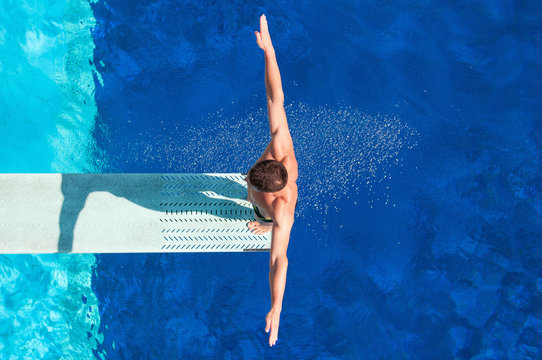 Diver on the springboard, ready to jump backwards