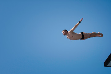 High diving. Diver leaps from high platform
