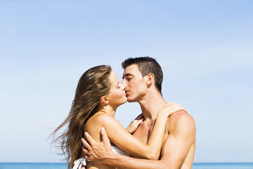 Couple kissing in summer sun light