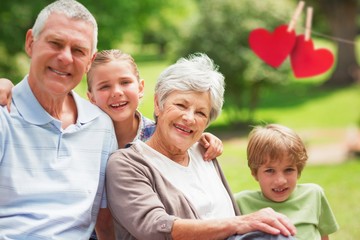 Composite image of smiling senior couple and grandchildren