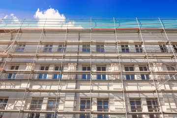 house exterior with scaffold - old town building facade restorat