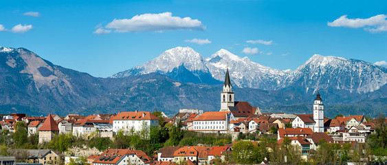 Panorama of Kranj, Slovenia, Europe. Kranj in Slovenia with St. Cantianus Church in the foreground and the Kamnik Alps behind - obrazy, fototapety, plakaty