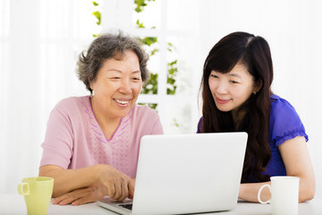 happy senior Mother and daughter learning  laptop