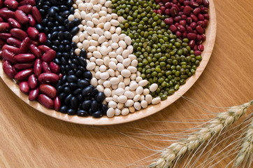Nut on wood ,whole grains background.Have green beans,red bean,black eyed peas and white bean.