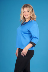 Beautiful young girl  posing on a blue background