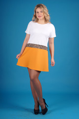 Beautiful young girl  posing on a blue background