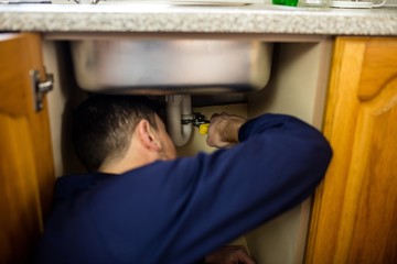 Plumber repairing a sink