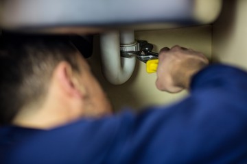 Plumber repairing a sink