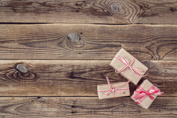 Background with gift boxes on wood grunge boards.