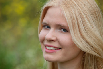 Naklejka premium Happy blonde girl outside