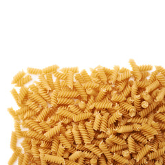Pile of dry rotini pasta over isolated white background