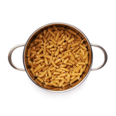 Metal pan filled with dry rotini pasta over isolated white background