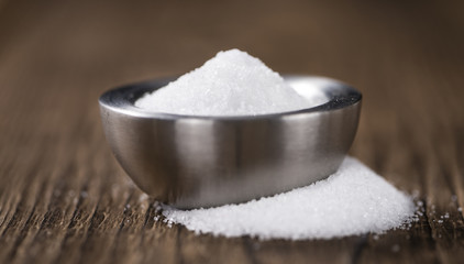 White Sugar (selective focus) on wooden background