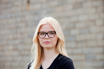 Young blonde girl with glasses smiling