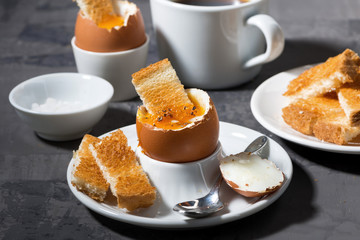 soft boiled egg, toasts and coffee for breakfast 