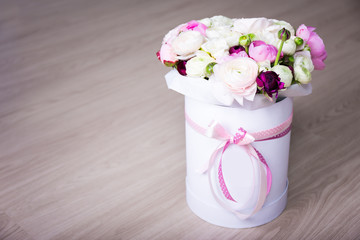 bouquet of summer flowers in white round box