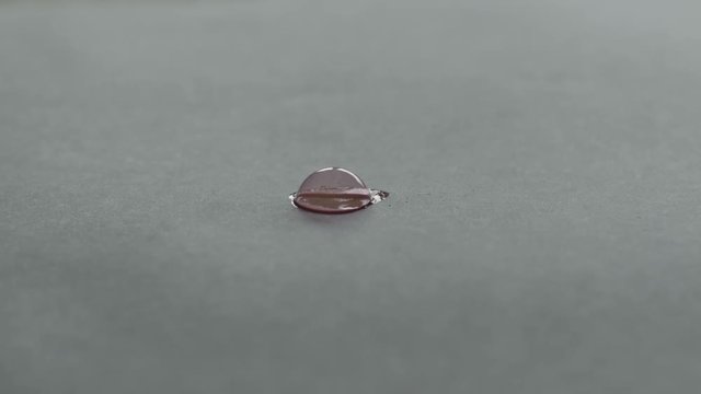 A small red bubble bursts on white paper