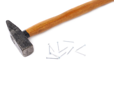 Big hammer with pile of nails over white isolated background