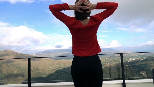 Young Woman Walking Out On Terrace And Stretching Her Arms On Terrace With Mountain View, Super Slow Motion
